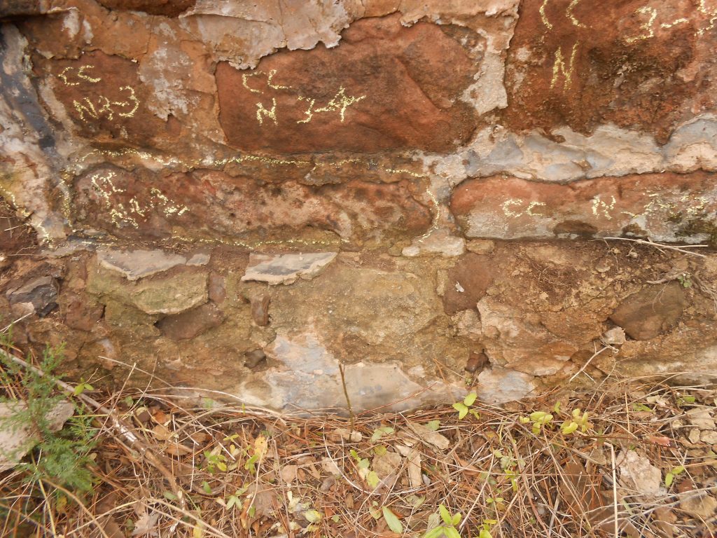 north wall of farmhouse foundation marked for reconstruction